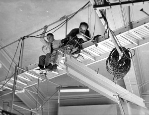 LF and client on scaffolding above the room set